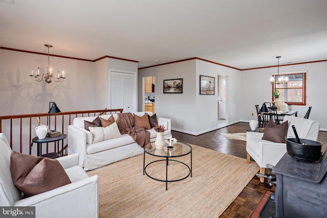 living room with ornamental molding, a notable chandelier, and dark parquet flooring