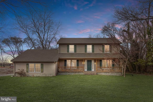 view of front of home with a yard and a porch