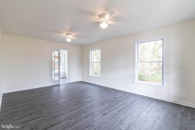 empty room featuring dark hardwood / wood-style flooring and ceiling fan