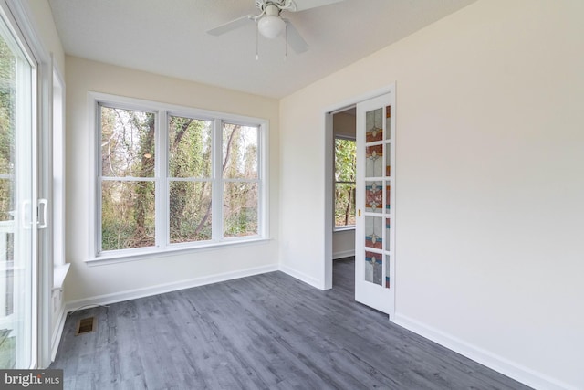 unfurnished sunroom featuring ceiling fan