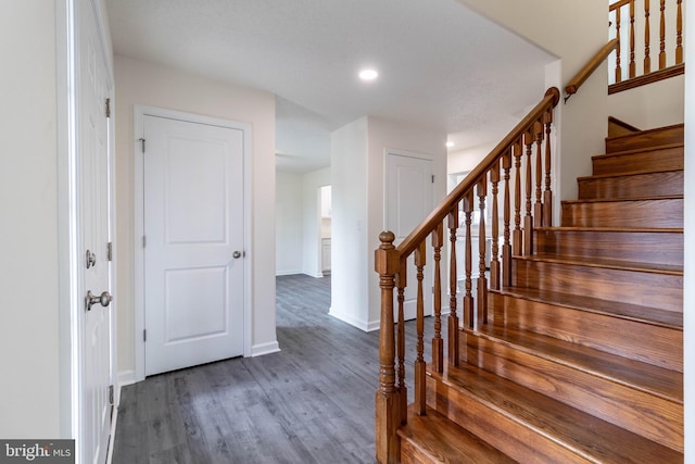 stairway with hardwood / wood-style flooring