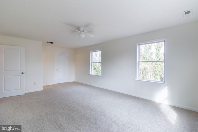 carpeted empty room featuring ceiling fan