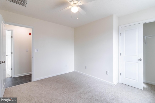 unfurnished bedroom featuring ceiling fan, carpet floors, and a closet