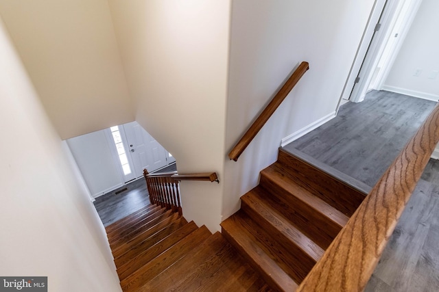 stairway with hardwood / wood-style floors