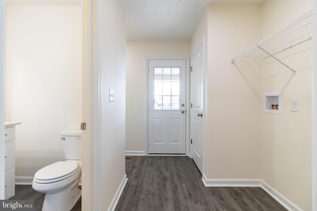 washroom featuring dark hardwood / wood-style flooring, washer hookup, and a textured ceiling