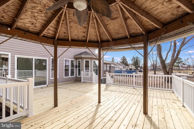 wooden deck featuring a gazebo and ceiling fan