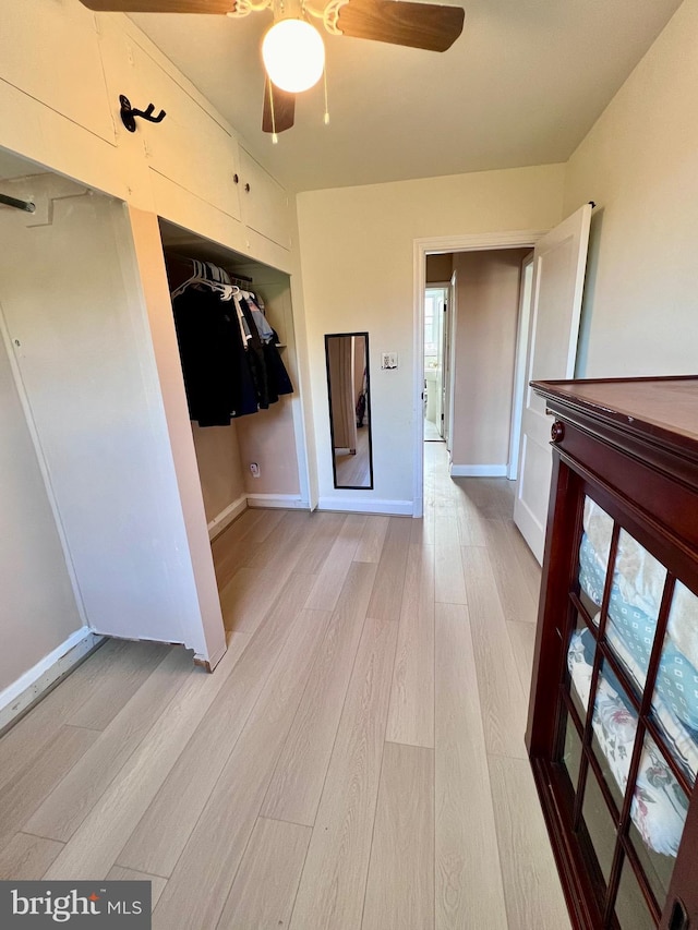 corridor with a wealth of natural light and light wood-type flooring