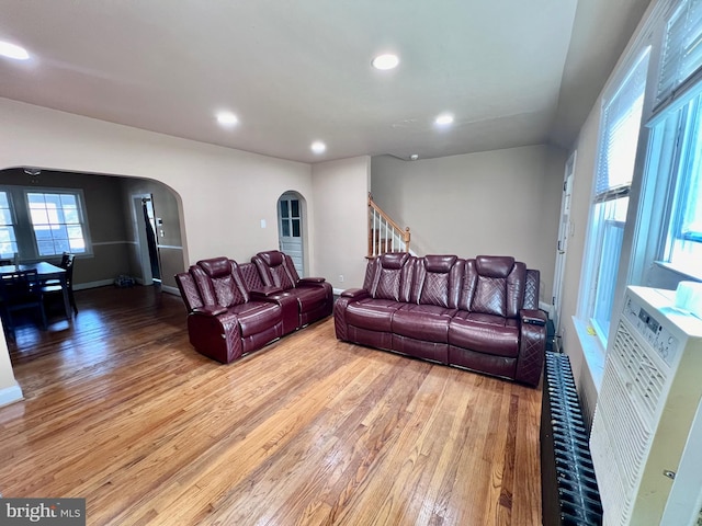 living room featuring radiator heating unit, hardwood / wood-style floors, and a healthy amount of sunlight