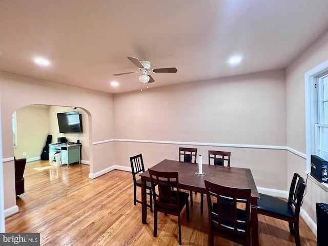 dining space featuring ceiling fan and light wood-type flooring