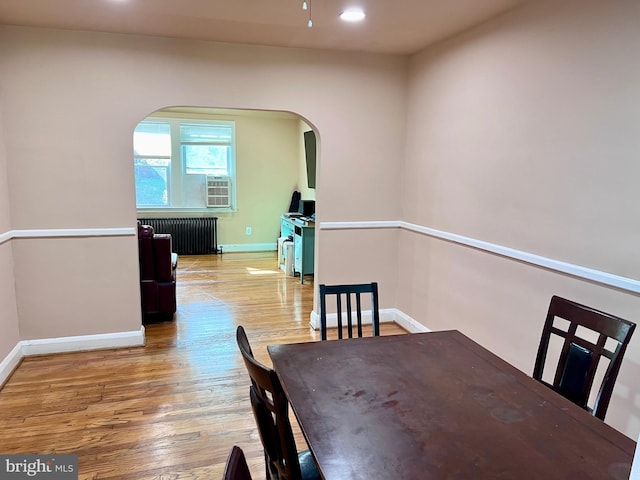 dining space featuring radiator and wood-type flooring