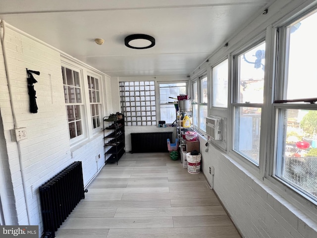 sunroom featuring radiator heating unit