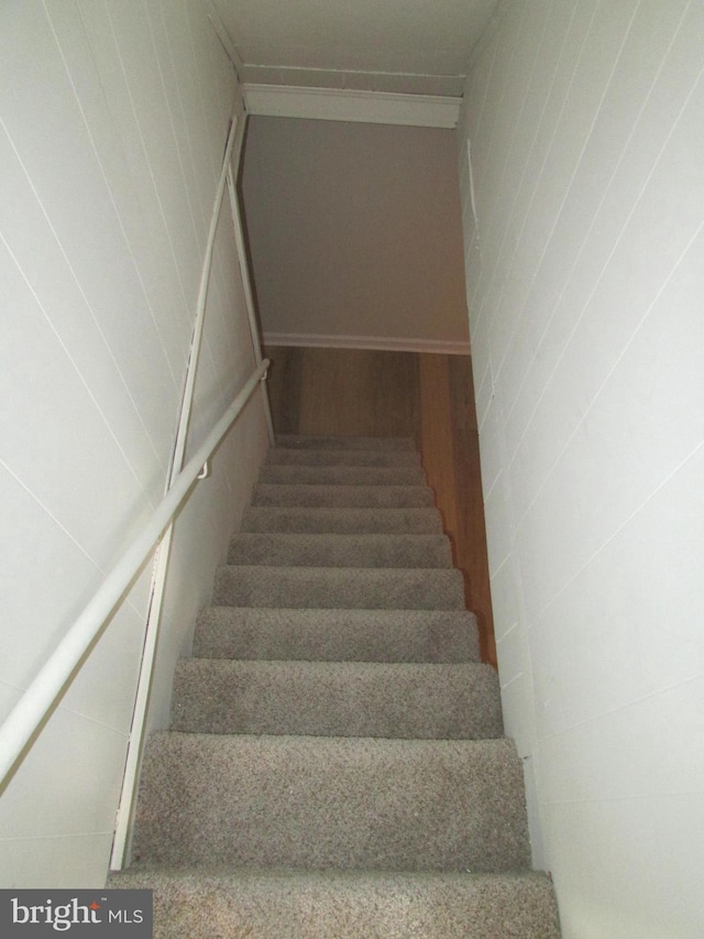 staircase with hardwood / wood-style flooring