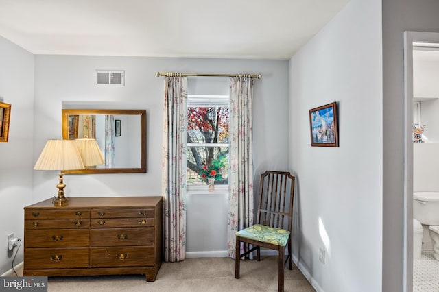 sitting room featuring light colored carpet