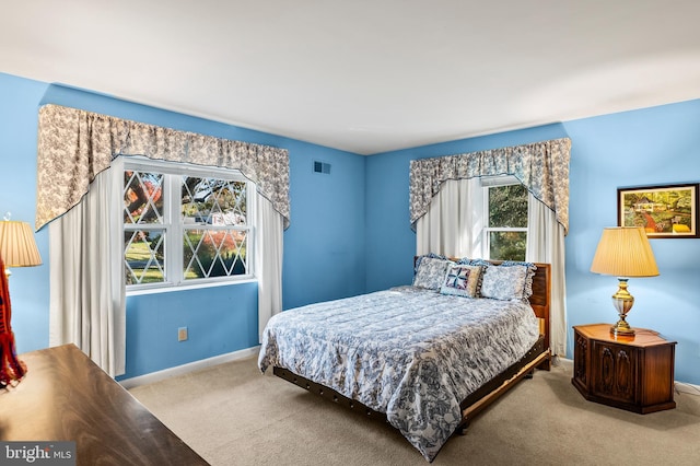 bedroom featuring carpet floors and multiple windows