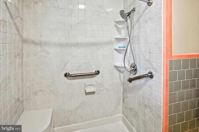 bathroom with a tile shower