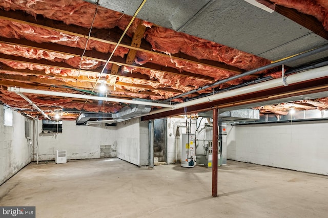 basement featuring gas water heater and heating unit