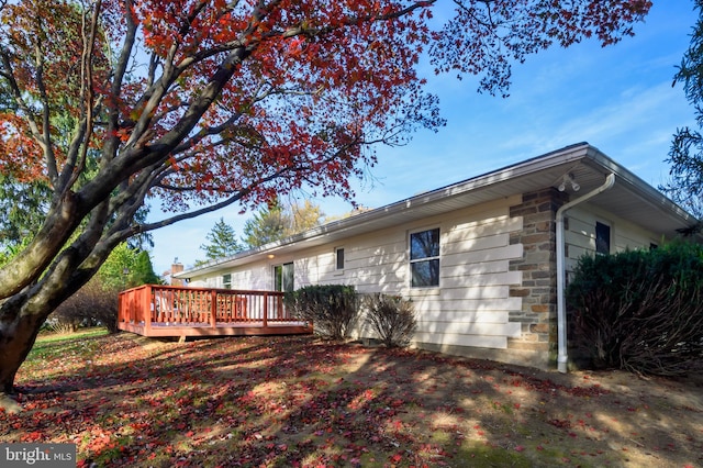 view of property exterior featuring a deck