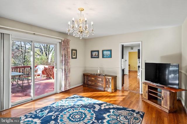 interior space with hardwood / wood-style flooring and an inviting chandelier