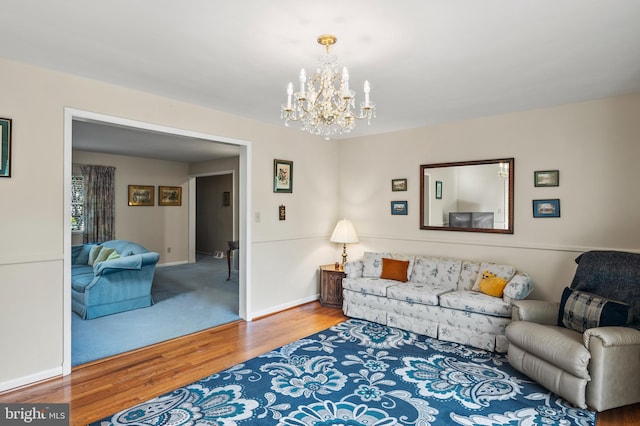 living room featuring wood-type flooring and a notable chandelier