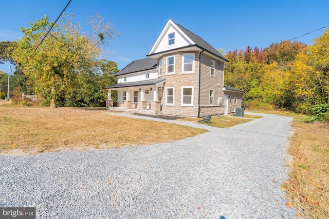 view of front of home featuring central air condition unit and a porch