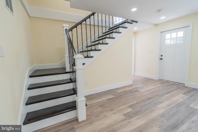 stairs with hardwood / wood-style floors