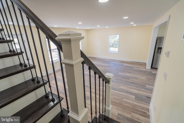 stairs featuring wood-type flooring