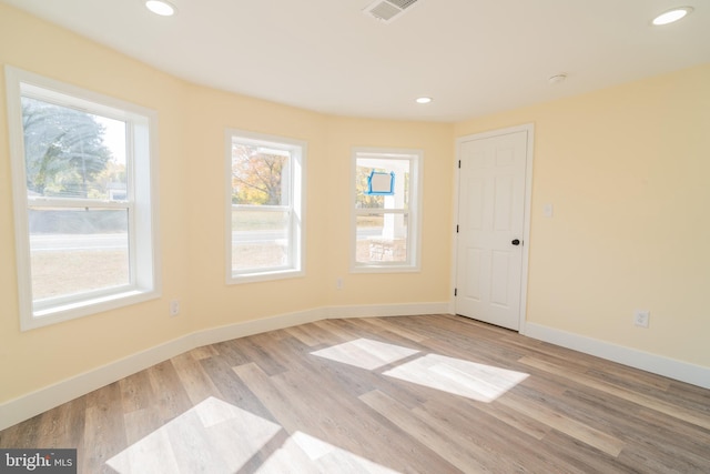 unfurnished room with light wood-type flooring