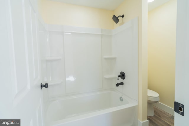 bathroom featuring toilet, shower / tub combination, and hardwood / wood-style floors