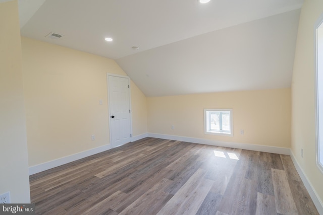 bonus room featuring light hardwood / wood-style floors and lofted ceiling