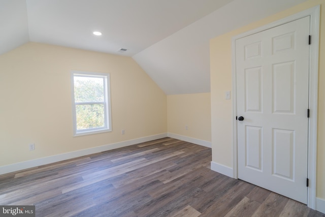 bonus room featuring wood-type flooring and vaulted ceiling