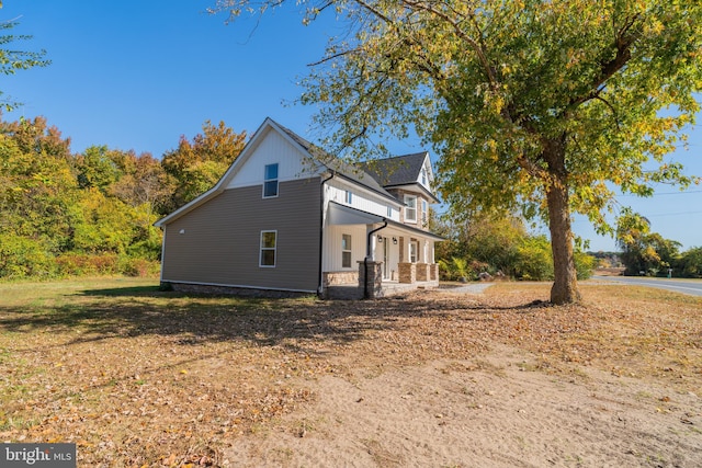 view of side of home featuring a porch