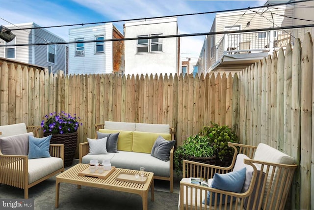 view of patio with an outdoor hangout area and a balcony