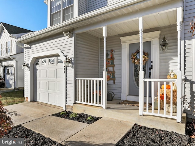 doorway to property with a garage and covered porch