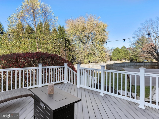 wooden terrace with a lawn