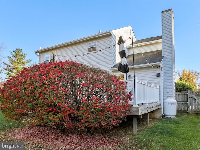 view of property exterior featuring a wooden deck