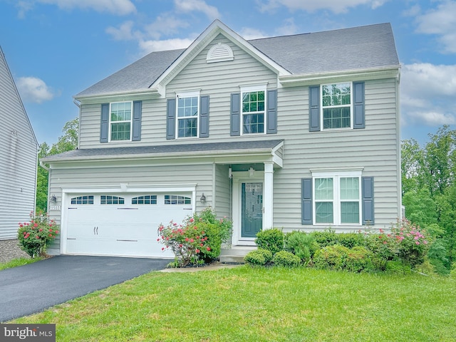 view of front of house with a garage and a front yard