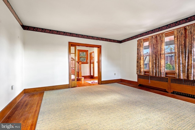 unfurnished room with hardwood / wood-style floors