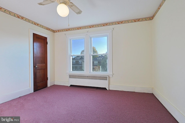 carpeted spare room featuring radiator and ceiling fan