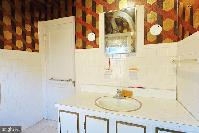 bathroom featuring vanity and tile walls