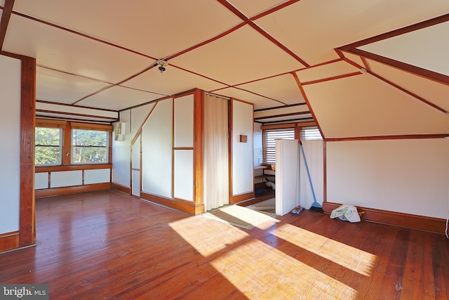 additional living space featuring hardwood / wood-style floors