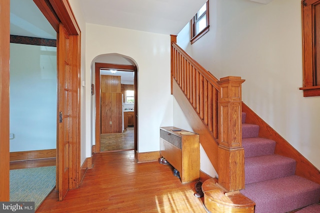 stairs with hardwood / wood-style floors