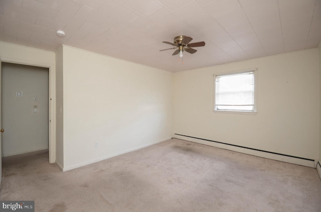 empty room featuring a baseboard heating unit, light colored carpet, and ceiling fan