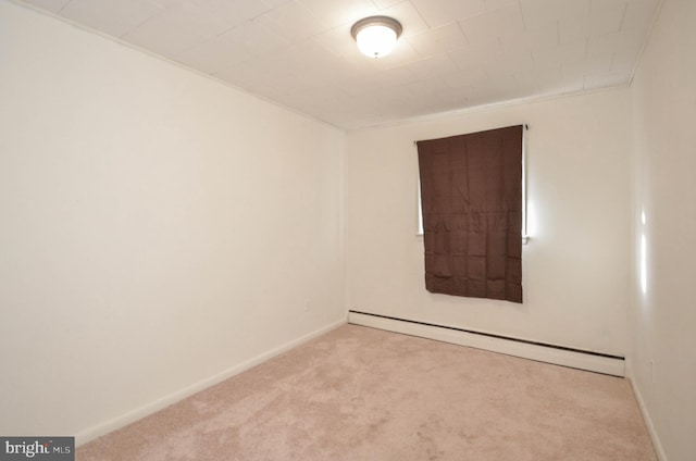 empty room with baseboard heating and light colored carpet