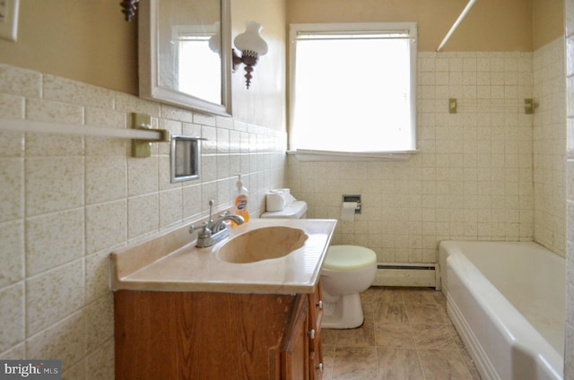 bathroom with toilet, vanity, tile walls, and a baseboard heating unit