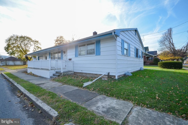 bungalow-style home with a porch and a front yard