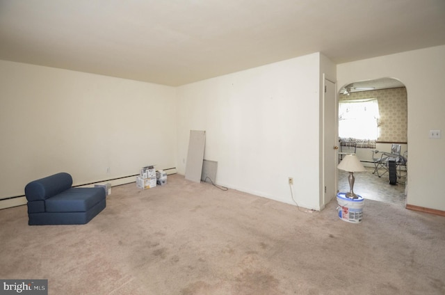 interior space with baseboard heating and carpet floors