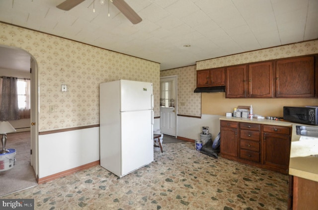 kitchen with ceiling fan, white fridge, and sink