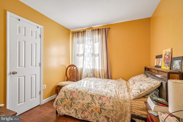 bedroom with hardwood / wood-style flooring