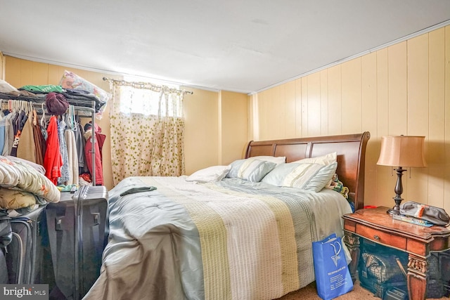 bedroom featuring wood walls