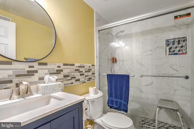 bathroom with vanity, a shower with shower door, and toilet